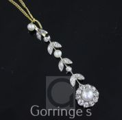 An early 20th century gold, platinum, cultured pearl and diamond pendant, of foliate design, with