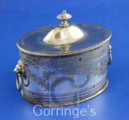 A late 19th/early 20th century Sheffield Plate oval two division tea caddy, with engraved foliate