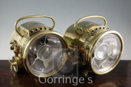 A pair of Bleriot of Paris brass bullseye motoring lamps, height 11in.