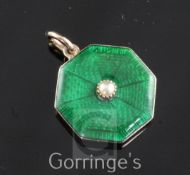 An Edwardian gold, green guilloche enamel and split pearl set octagonal pendant locket, 0.75in.