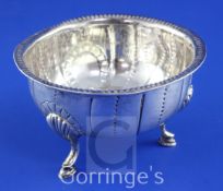 A George III Irish silver circular bowl, with engraved armorial, initials and spiral decoration,