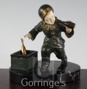 O. Gerard. An early 20th century bronze and ivory figure of a child pierrot, holding a bottle of