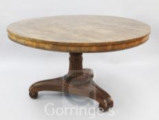 A Regency rosewood breakfast table, with circular top and ovolo frieze, on fluted stem with