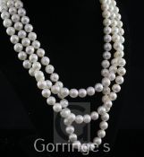 A modern triple strand cultured pearl necklace with 18ct gold, diamond and cultured pearl set oval