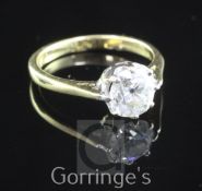 An 18ct gold and solitaire diamond ring, the old round cut stone weighing approximately 1.40-1.