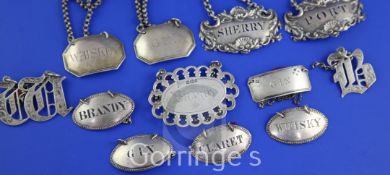 Twelve assorted 19th century silver wine labels, including a set of four beaded oval labels, "