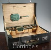 A 1930's silver and green guilloche enamel travelling toilet set by Goldsmiths and Silversmiths Co