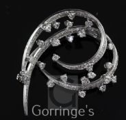 A modern 18ct white gold and diamond set open scroll brooch, 1.75in.