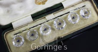 A cased set of six early 20th century rock crystal and sapphire set dress buttons, of circular form,