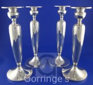 A set of four early 20th century American sterling silver candlesticks by Dominick & Haft, New York,