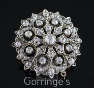 A Victorian gold, silver and diamond cluster pendant brooch, of pierced domed circular form with