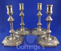 A set of four Edwardian 18th century style silver candlesticks by Hawkesworth, Eyre & Co, with