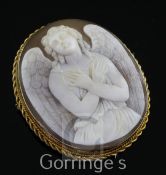 A 9ct gold mounted cameo pendant/brooch carved with an angel with folded arms, inscribed en