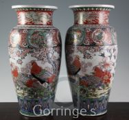 A pair of large Japanese Kutani porcelain ovoid vases, Meiji period, each painted to the central