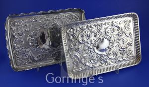 Two late 19th/early 20th century repousse silver dressing table trays, both of rectangular form with