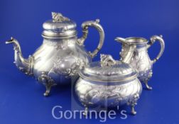 A late 19th century German 800 standard matched silver three piece tea set, of baluster form, with
