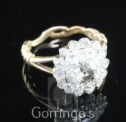 A 19th century gold, silver and diamond cluster ring, set with rose and old mine cut stones, size