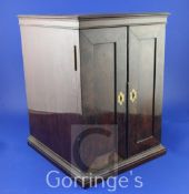 A 19th century mahogany coin collector's cabinet the flame-figured panelled doors enclosing 27