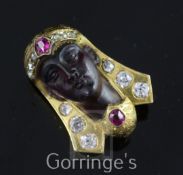 A late 19th/early 20th century gold, ruby, diamond and amethyst glass? clip brooch, modelled as