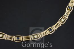 An Edwardian 15ct gold, sapphire and diamond gate link bracelet, set with three oval cut sapphires