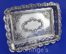 An Edwardian pierced silver rectangular dish on scroll legs, with repousse scroll decoration, S.