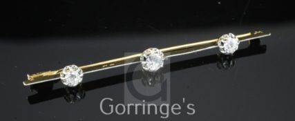 A mid 20th century French 18ct gold, platinum and three stone diamond set bar brooch, numbered 7382,