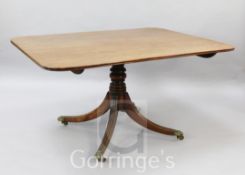 A Regency mahogany breakfast table, with rounded rectangular tilt top, on ring turned stem and