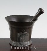 A Charles I bronze "death mask" mortar, c.1665, 4.25in. with associated pestle