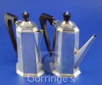 A George V silver cafe au lait pair by Mappin & Webb, of tapering octagonal form, with bakelite