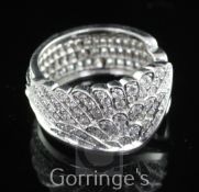 A modern Garrard & Co 18ct white gold and pave set diamond dress ring, the open shank with channel