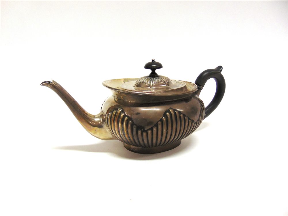 A LATE VICTORIAN SILVER TEAPOT by Edward Hutton, London 1888, of oval gadrooned form with a cape - Image 2 of 2