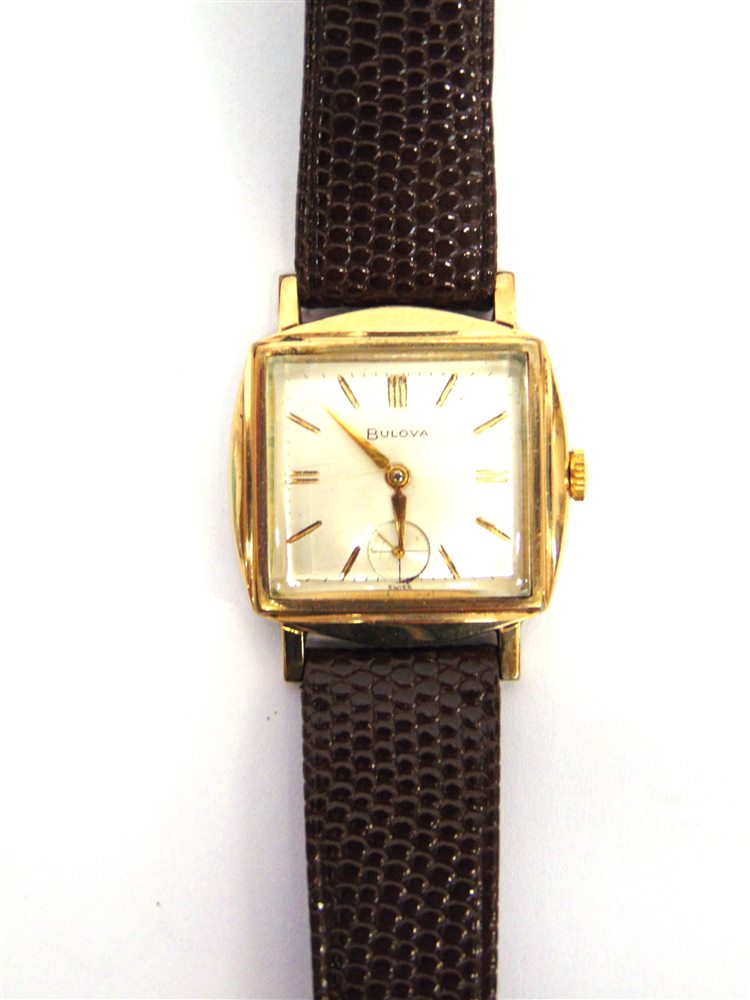 BULOVA, A GENTLEMAN'S 1950'S GILT WRIST WATCH the rectangular shaped case and white dial with gilt