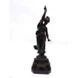 A PATINATED METAL FIGURE OF A LADY IN CLASSICAL DRESS holding aloft a flaming torch, on octagonal