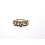 A LATE VICTORIAN FIVE STONE DIAMOND RING the graduated silver collet set old mine cuts totalling