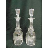 A PAIR OF GLASS DECANTERS AND STOPPERS of elongated octagonal form with star-cut bases, 37.5cm high
