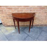 A MAHOGANY DEMI-LUNE CARD TABLE on square tapering supports, 84cm wide 42cm deep 71cm high