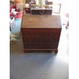 A GEORGE III PROVINCIAL OAK BUREAU with stepped interior fitted with well over two short and two