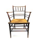 A VICTORIAN ASH AND STAINED BEECH RUSH SEATED 'SUSSEX' ARMCHAIR, probably Phillip Webb for