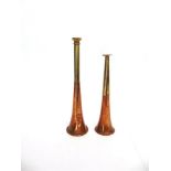 A COPPER AND BRASS MOUNTED HUNTING HORN 24.5cm long; and another smaller hunting horn, 20.5cm