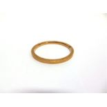 A HOLLOW ARM RING stamped '9ct', of hollow square section, 0.5cm wide, 7cm internal diameter, 13.