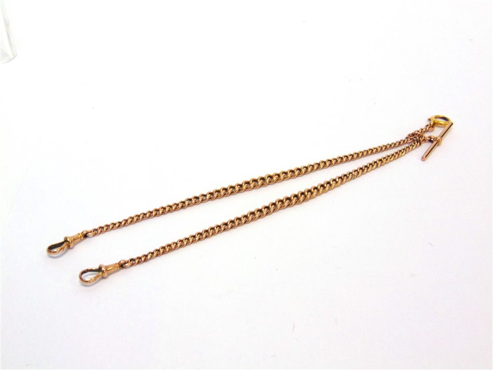 A DOUBLE ALBERT WATCH CHAIN stamped '9ct', of graduated hollow curb links, with two swivels, a T bar