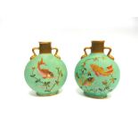 A PAIR OF OLD HALL MOON FLASKS polychrome decorated with fish swimming amongst reeds, with twin gilt