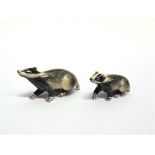 A PAIR OF SATURNO SILVER AND ENAMEL BADGERS, the larger approximately 6cm long