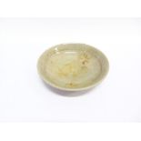 A CELADON GLAZED STONEWARE BOWL with incised decoration, 22.5cm diameter