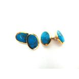 A PAIR OF 9 CARAT GOLD TURQUOISE SET CUFFLINKS the oval panels with chain connectors, 11g gross,