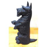 A CAST COMPANION SET in the form of a Scottie Dog sat on its haunches, and hung with fire tongs