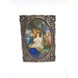 AN UNMARKED PIERCED SILVER COLOURED FRAME rectangular, with a painted image of a sleeping maiden