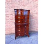 A MAHOGANY SERPENTINE FRONT CHEST ON CHEST fitted with brushing slide, with carved blind fret