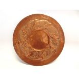 A LARGE NEWLYN STYLE ARTS AND CRAFTS COPPER CHARGER, embossed and chased decoration of a