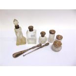 A SILVER MOUNTED GLASS SCENT BOTTLE Birmingham 1905; with five glass toilet bottles with silver
